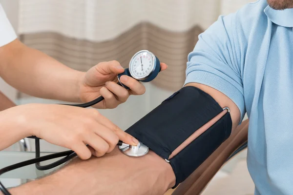Doctor Measuring Blood Pressure