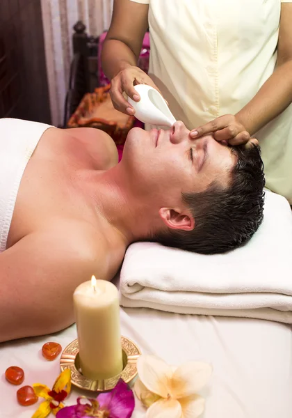 Man engaged in Ayurvedic spa treatment
