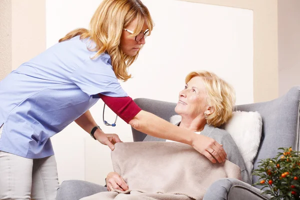 Nurse caring for elderly woman