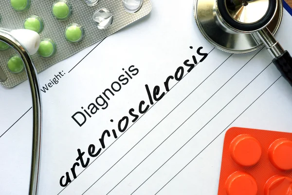 Diagnostic form with diagnosis arteriosclerosis and pills.