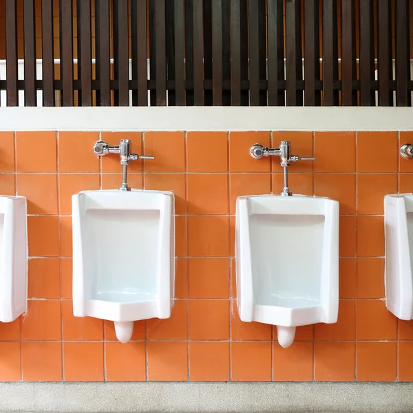Decor interior of white urinals in men bathroom toilet